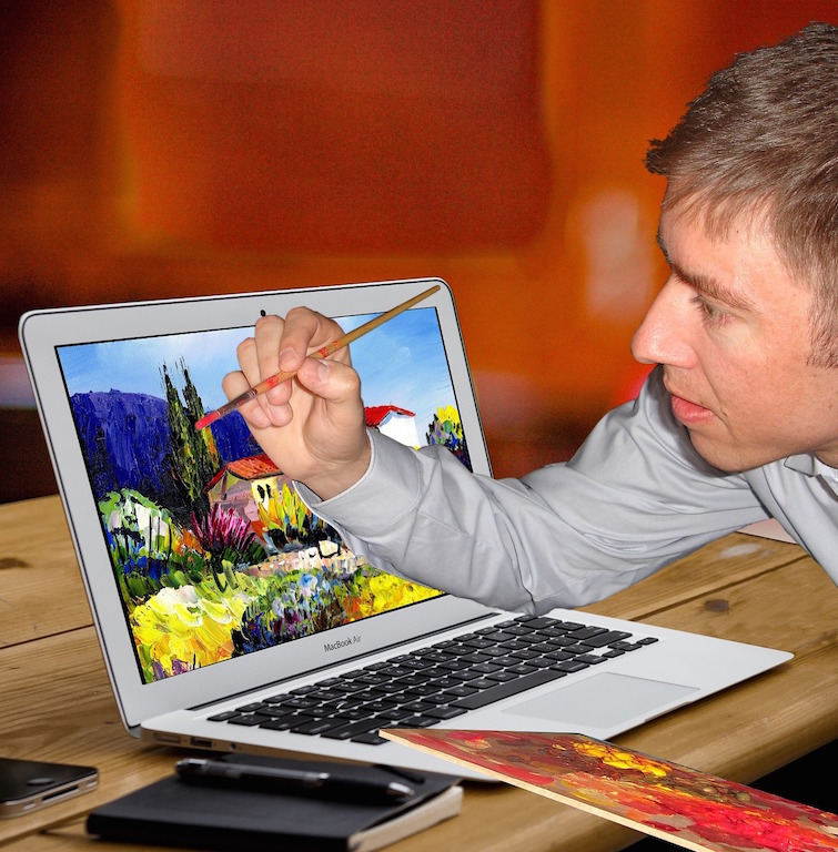 man painting a picture of a landscape on a laptop screen