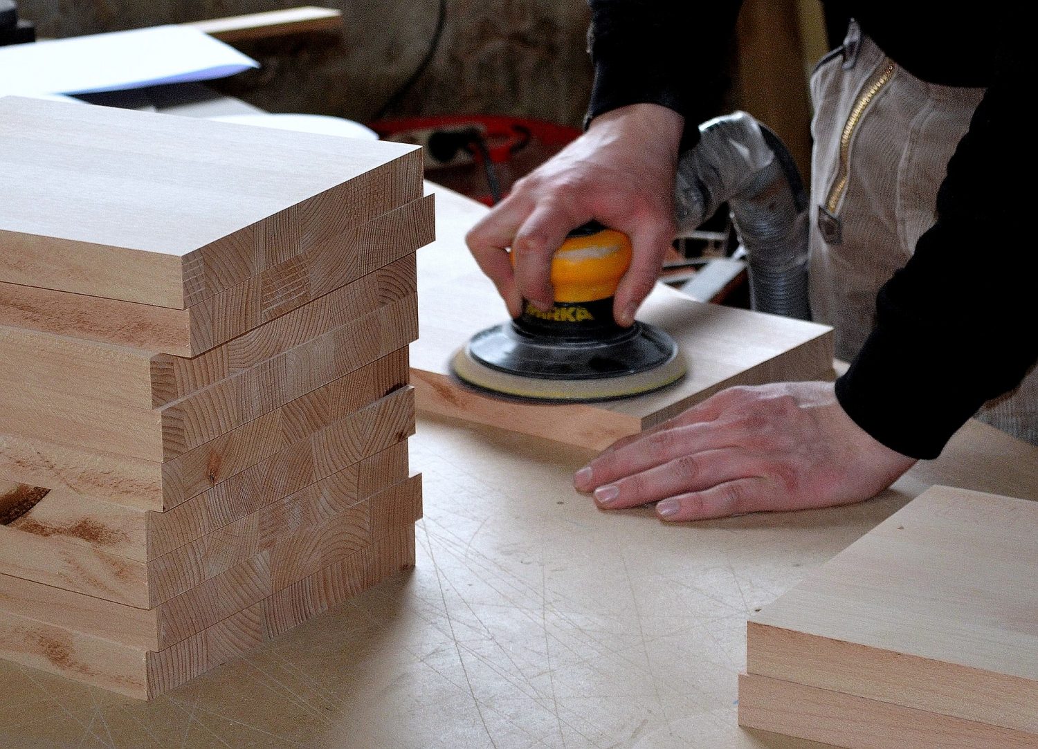 Man sanding a plank of wood