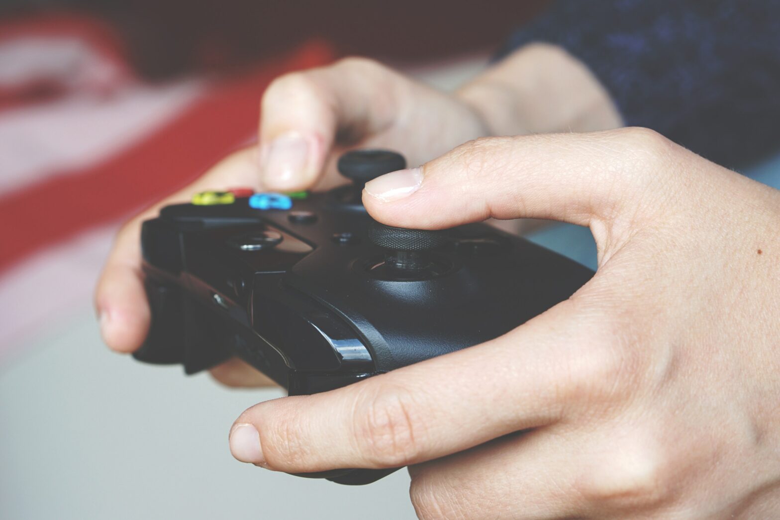 hands holding a gaming console controller