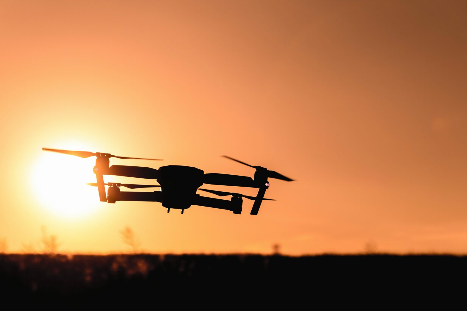 drone in the air with an orange sky