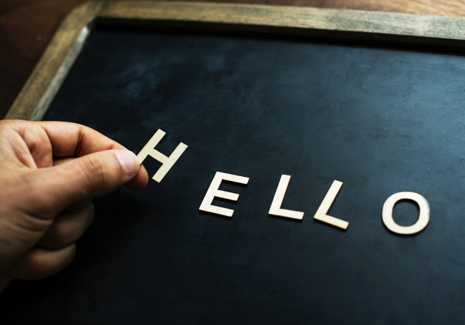 black board in wood frame with letters spelling hello