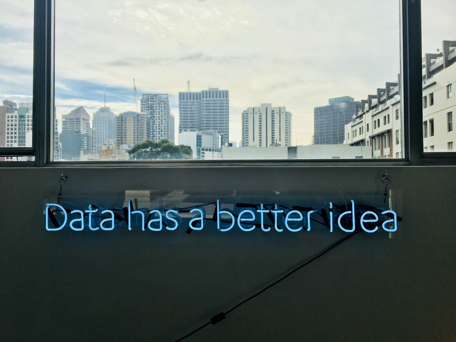 window view of city skyline with blue data has a better idea text