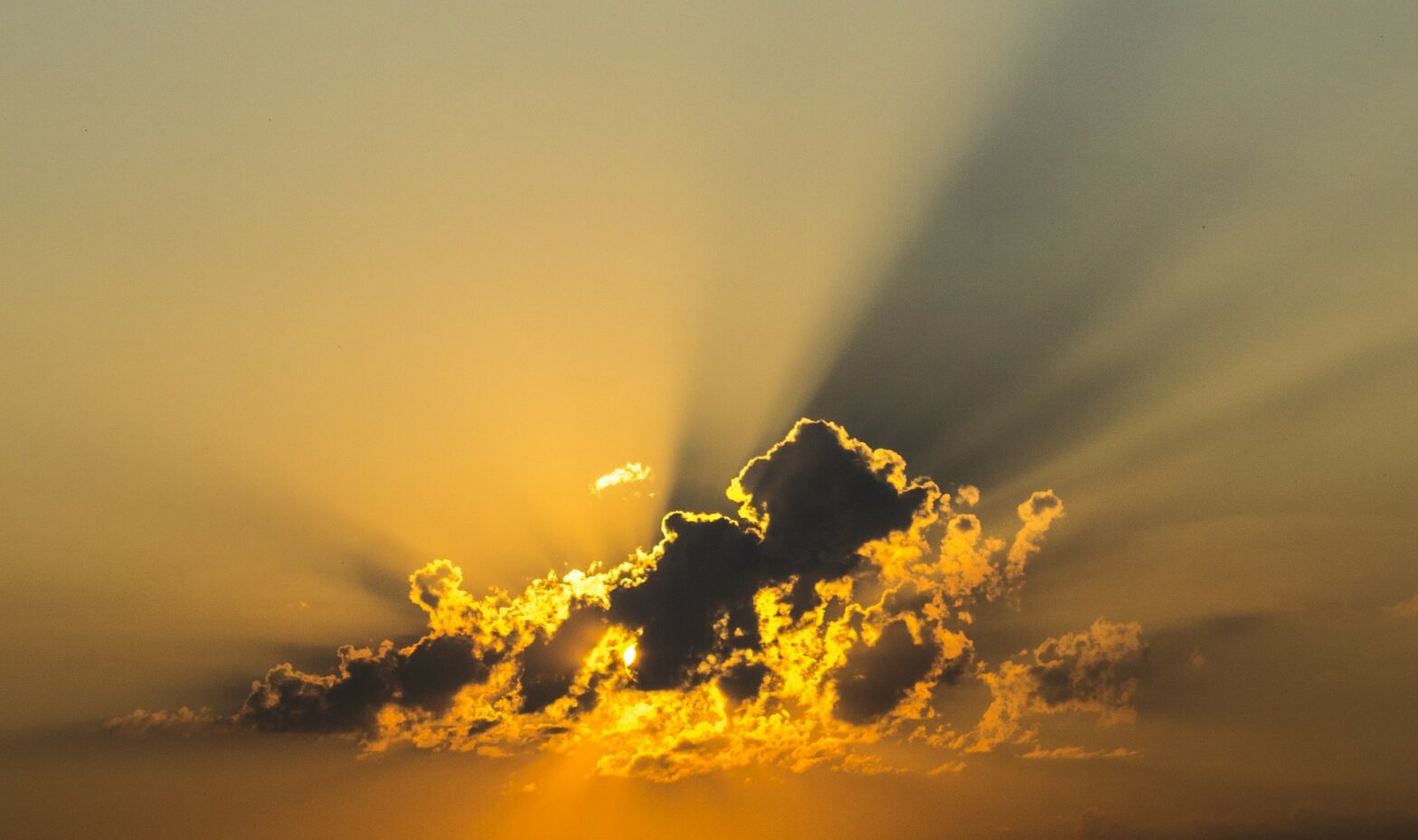 blue sky with yellow sunburst cloud